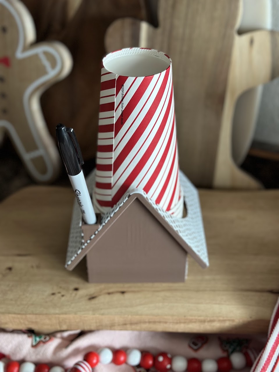 Gingerbread House Party Cup Holder Back View – A festive gingerbread house-themed cup holder with a marker slot, perfect for Christmas parties and hot cocoa bars.