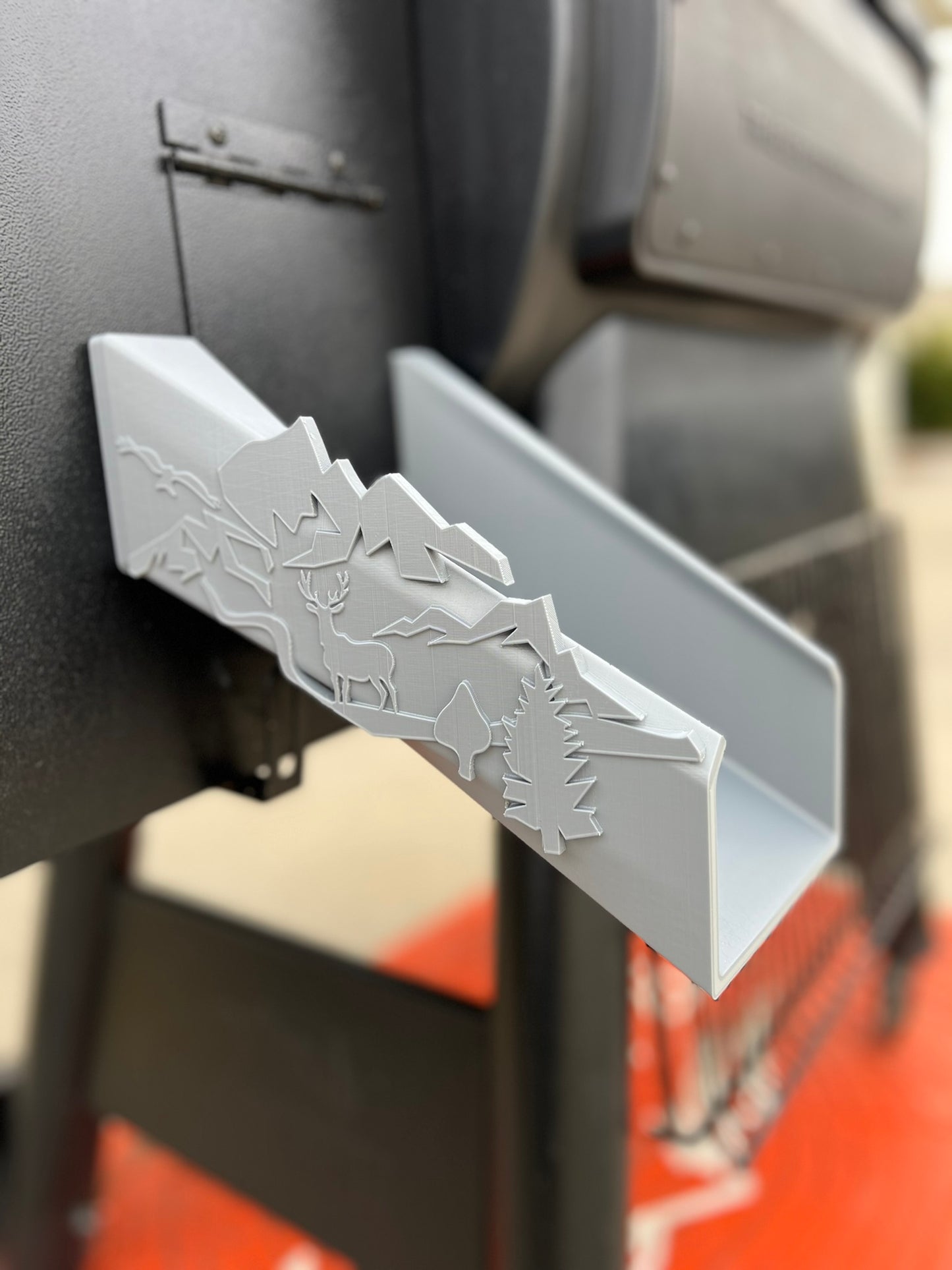 Traeger grill pellet chute in durable plastic with magnetic attachment and rustic deer and forest design details.