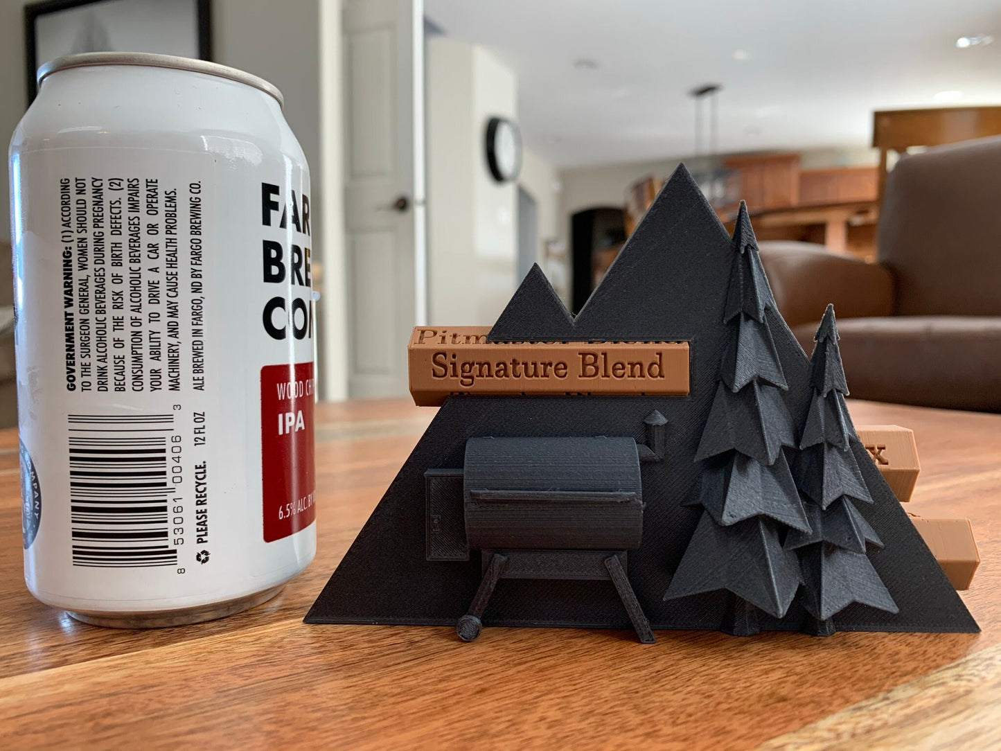 Close-up of a 3D printed pellet label magnet with detailed mountain design and hidden magnets inside the log for secure attachment.