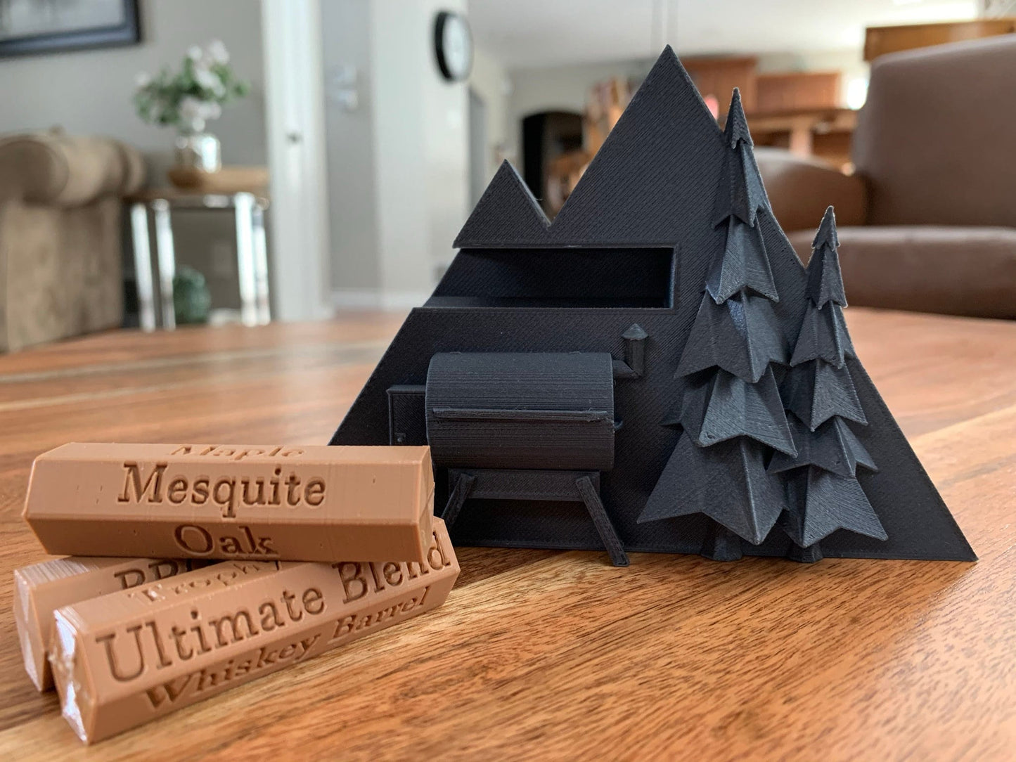 Close-up of a 3D printed pellet label magnet with detailed mountain design and hidden magnets inside the log for secure attachment.