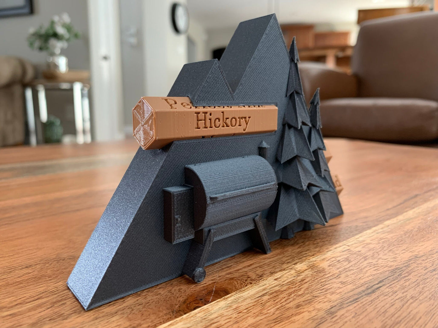 Close-up of a 3D printed pellet label magnet with detailed mountain design and hidden magnets inside the log for secure attachment.