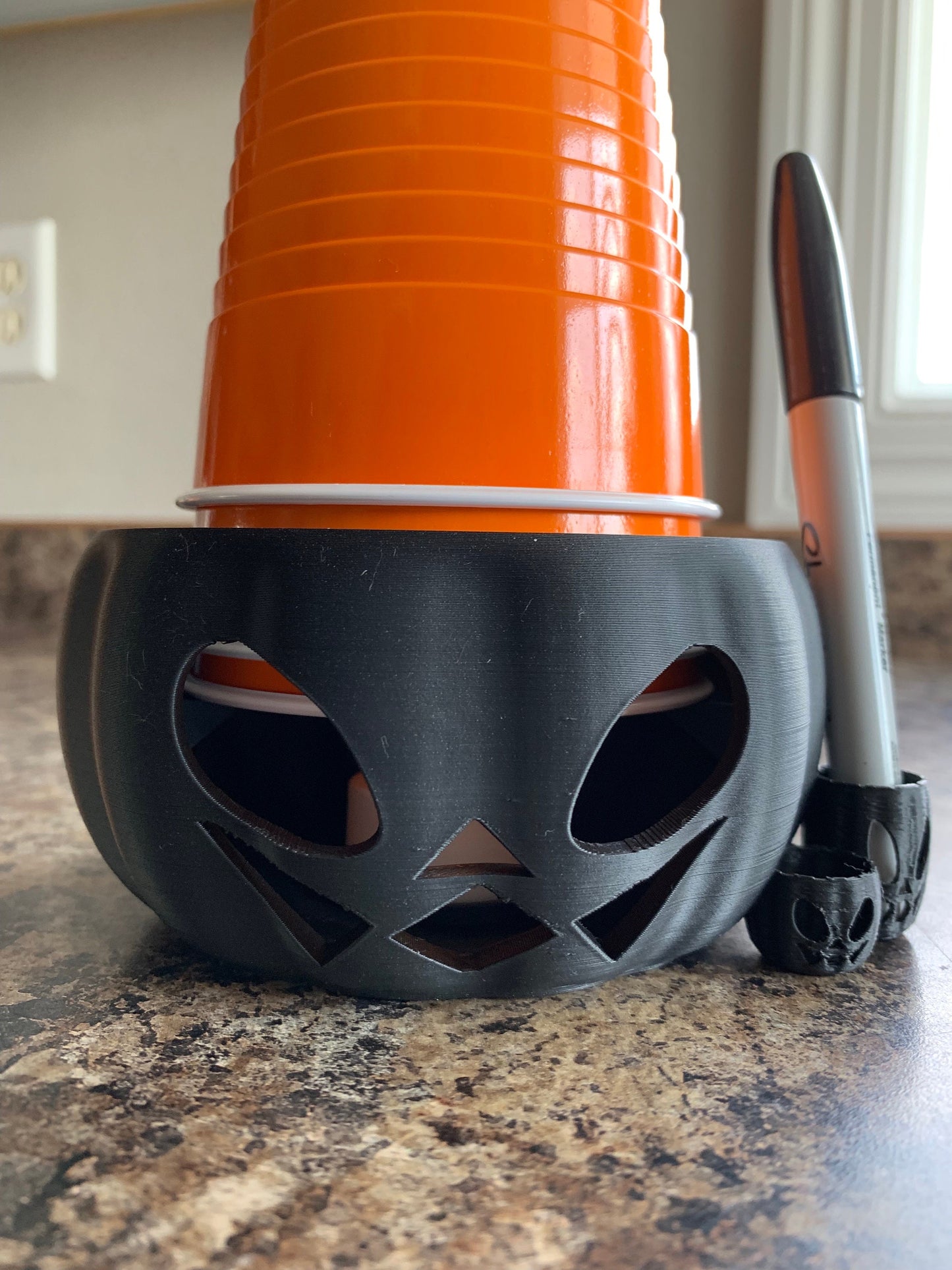 Close-up view of durable plastic Pumpkin Party Cup Holder designed for 14, 16, and 18 oz cups.
