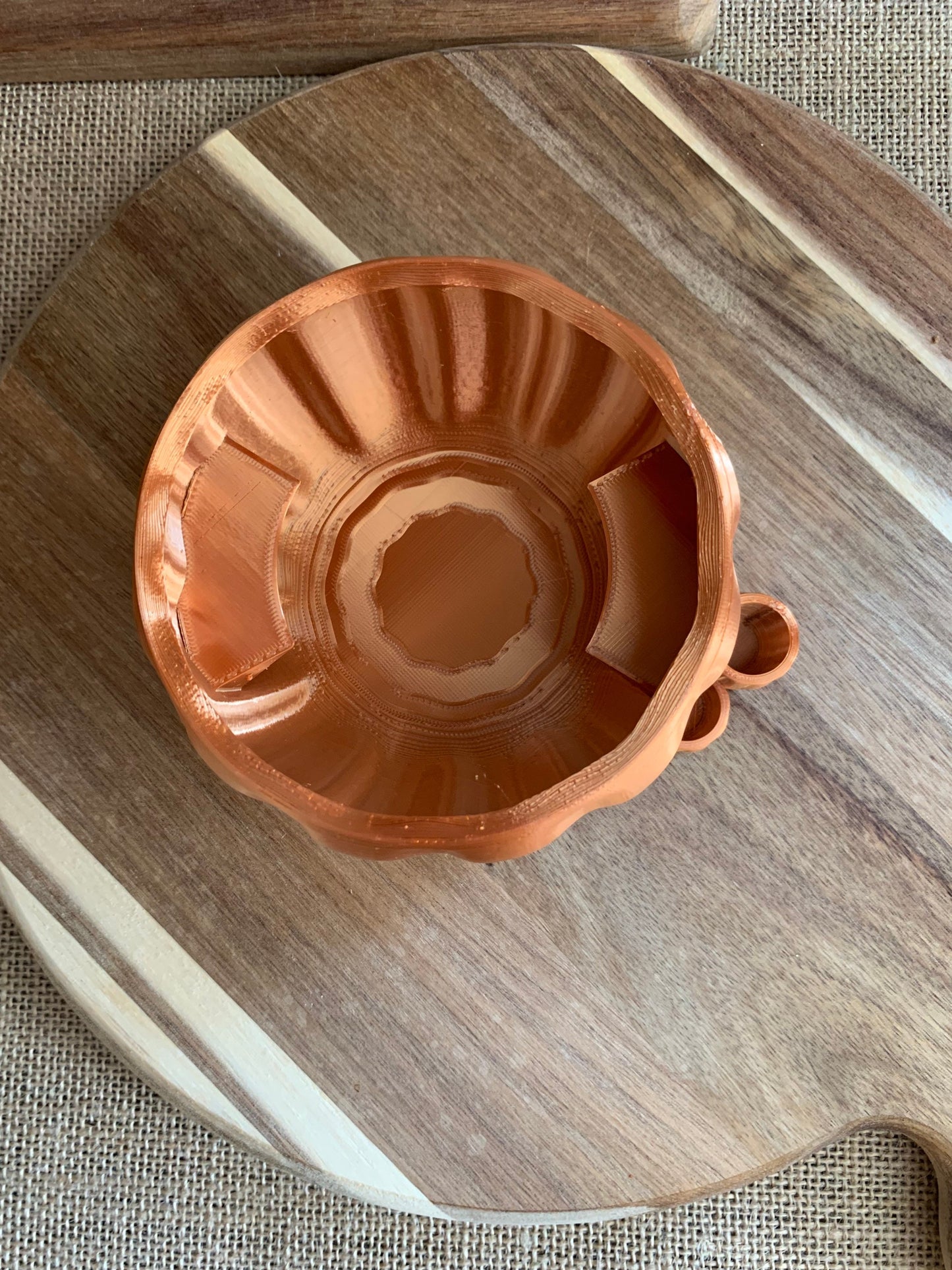Top view of a copper pumpkin party cup holder displaying its rustic charm and marker slot detail.