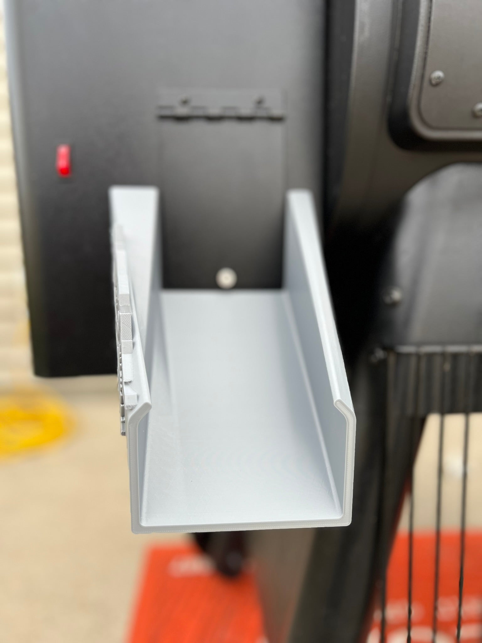 Pellet chute accessory for Traeger grill with nature-inspired deer and forest accents for easy pellet discharge.