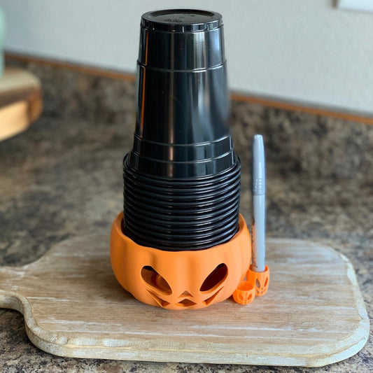 Product image of a Halloween drink cup holder featuring an integrated pen holder to prevent mix-ups.